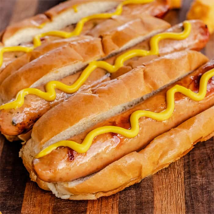Hofmann German Franks Natural Casing in buns with mustard
