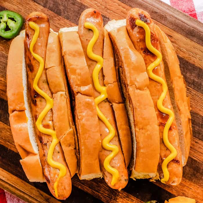 3 hot dogs in buns with Hofmann Traditional Yellow Mustard