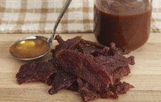 Hofmann Beef Jerky Honey BBQ on table with sauces
