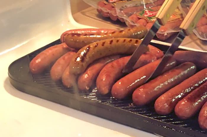 Sausages and hot dogs cooking on stovetop